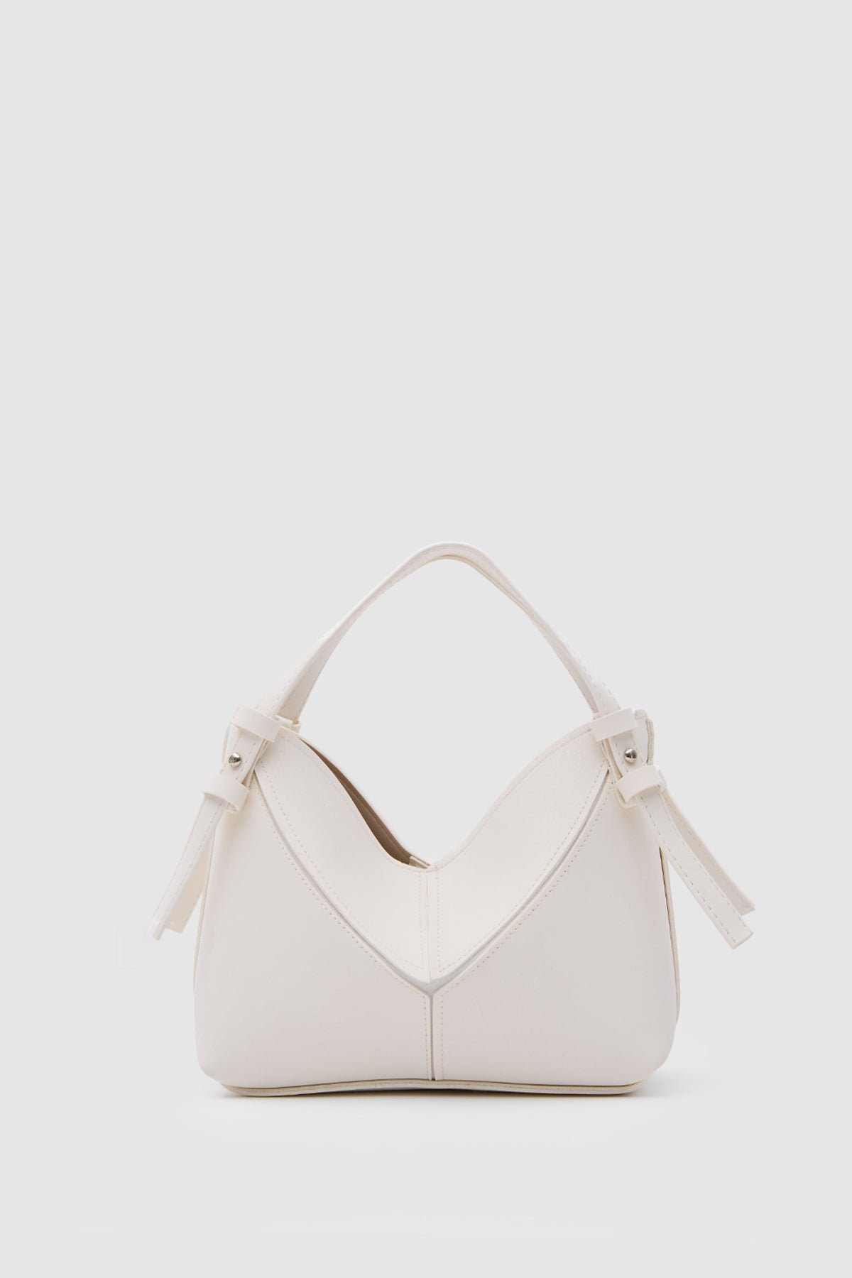 Simak Asymmetric Charm Crossbody Bag in vanilla – women's crossbody bag by Nouva